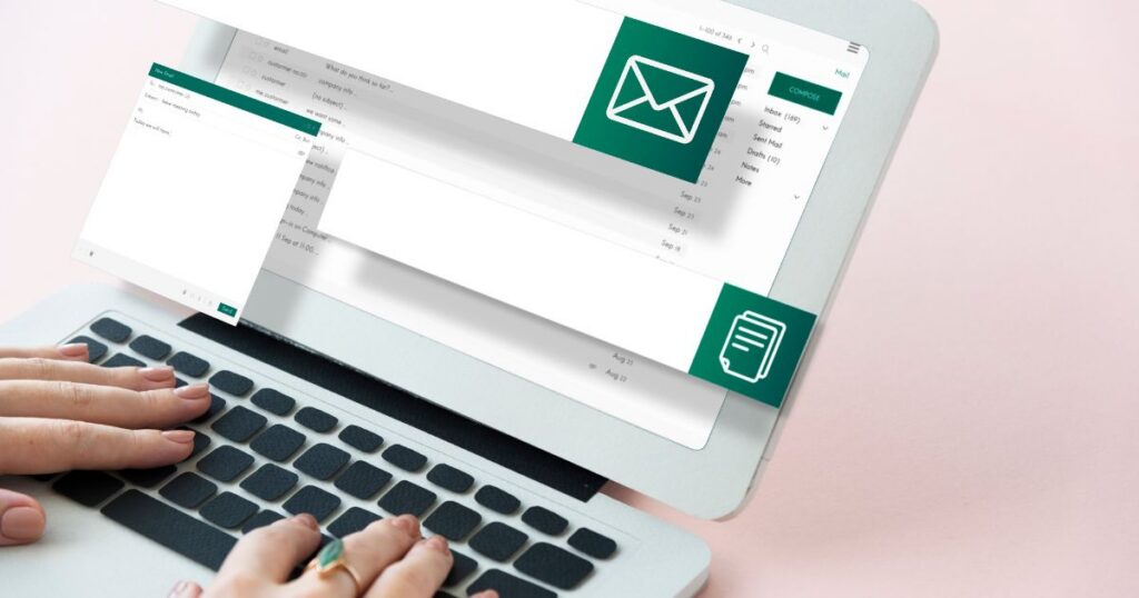 Person using a laptop to compose an email, featuring an open email interface and a message draft on the screen.