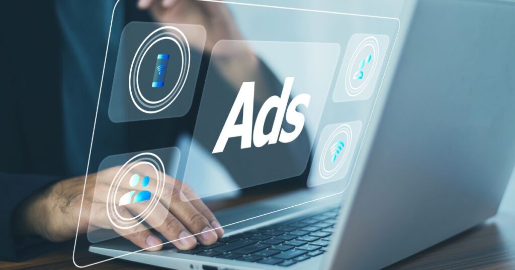 A person typing on a laptop, with a virtual display showcasing advertisements on the screen.