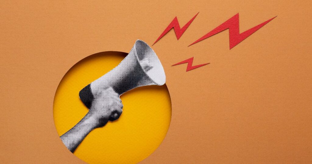 A hand holding a megaphone emits red sound waves against a yellow and orange background, symbolizing communication and announ